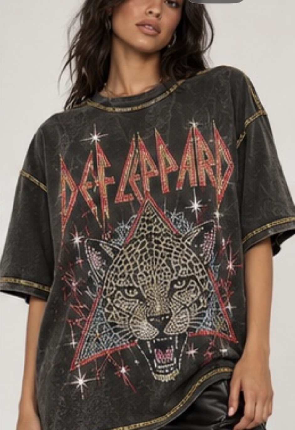 Model styled in a washed Def Leppard graphic top with gold trim