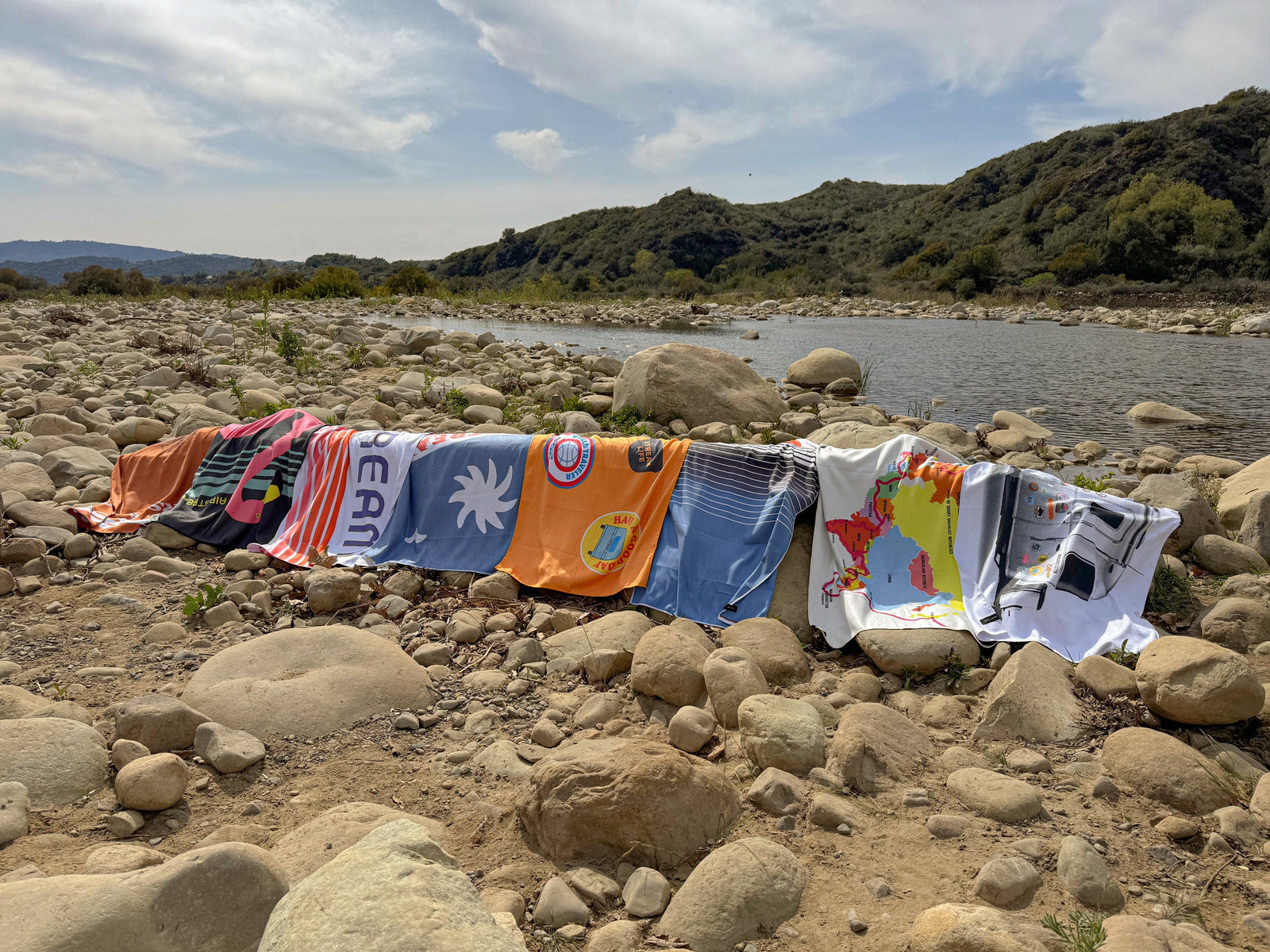 Slowtide and Airstream woven towels and blankets styled outside a silver Airstream trailer